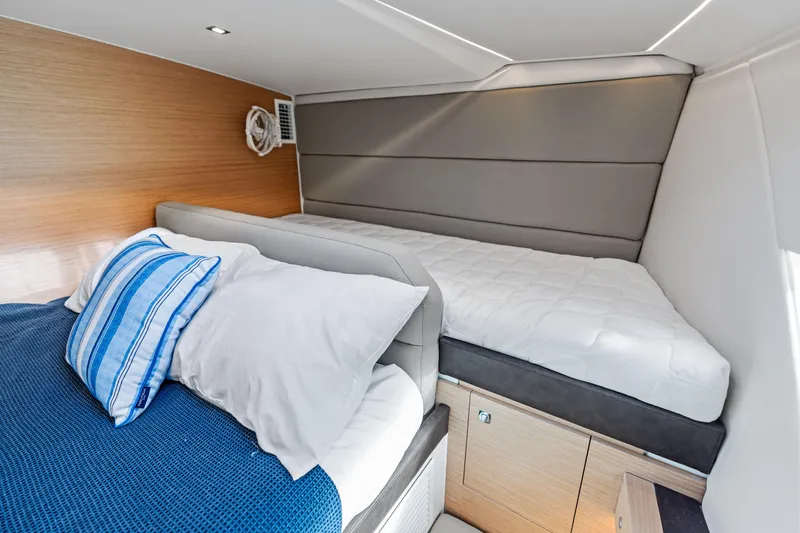  Yacht Photos Pics Interior cabin of 2025 Makai M37 with cozy bedding and modern design.