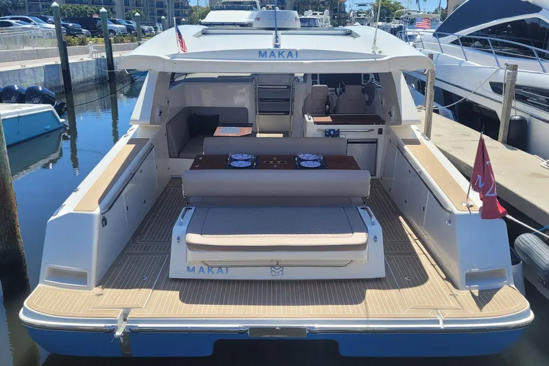  Yacht Photos Pics 2025 Makai M37 yacht docked, featuring spacious deck and seating area.