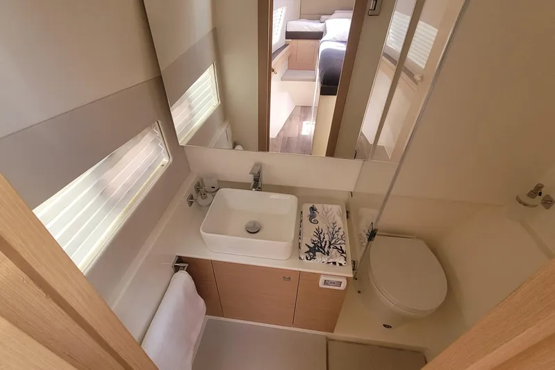 Yacht Photos Pics Modern bathroom in 2025 Makai M37 yacht with sleek sink, toilet, and mirror.