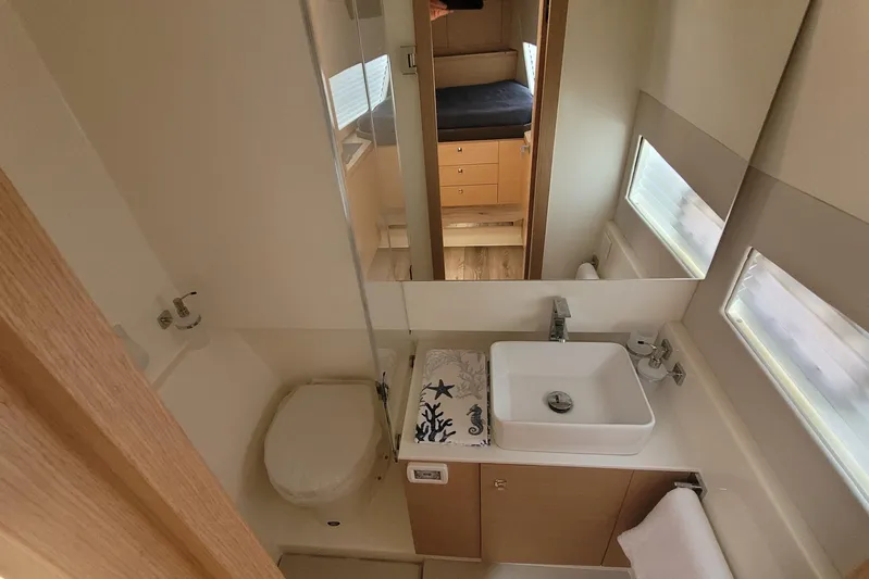  Yacht Photos Pics Modern bathroom in 2025 Makai M37 yacht with sink, toilet, and mirror.