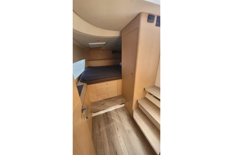  Yacht Photos Pics 2025 Makai M37 interior cabin with wooden finish and cozy bed setup.