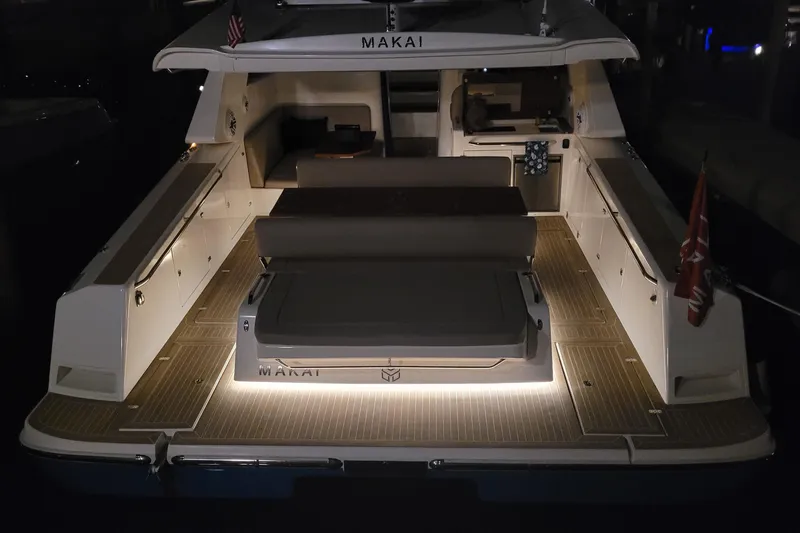  Yacht Photos Pics 2025 Makai M37 yacht with illuminated deck at night, showcasing luxury and elegance.