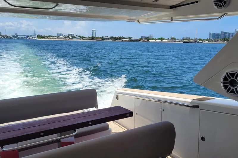  Yacht Photos Pics Luxury Makai M37 yacht cruising on blue waters, 2025 model, with scenic coastal view.