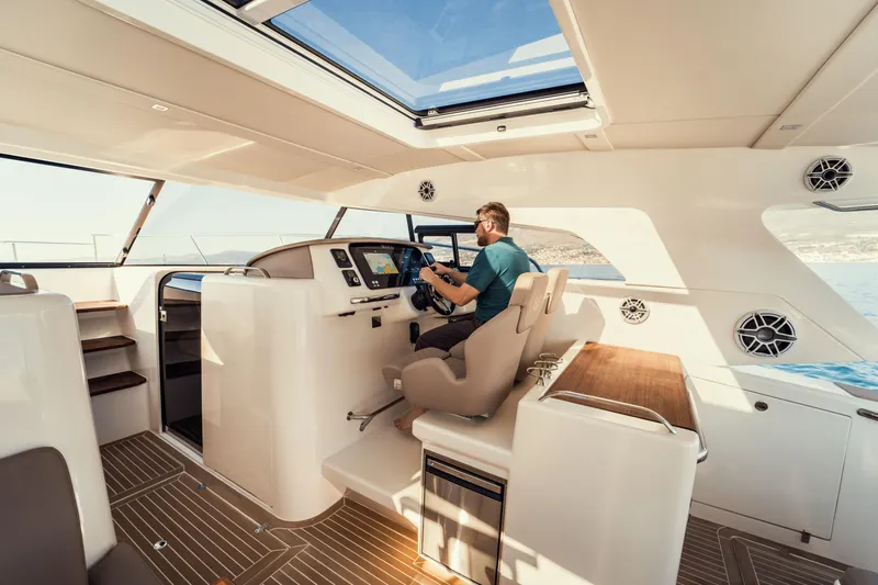  Yacht Photos Pics Interior of 2025 Makai M37 yacht with modern helm and panoramic windows.