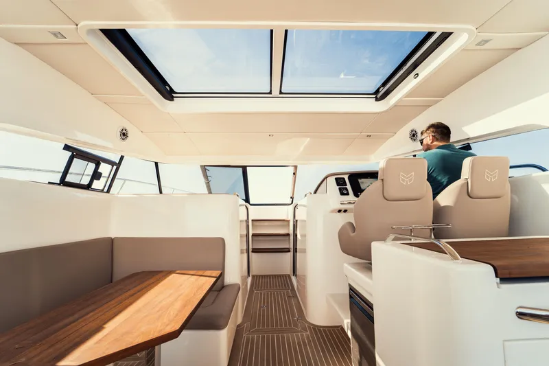  Yacht Photos Pics Luxurious interior of 2025 Makai M37 yacht with modern seating and panoramic windows.