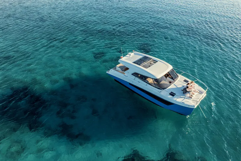  Yacht Photos Pics 2025 Makai M37 yacht cruising on clear blue ocean waters.