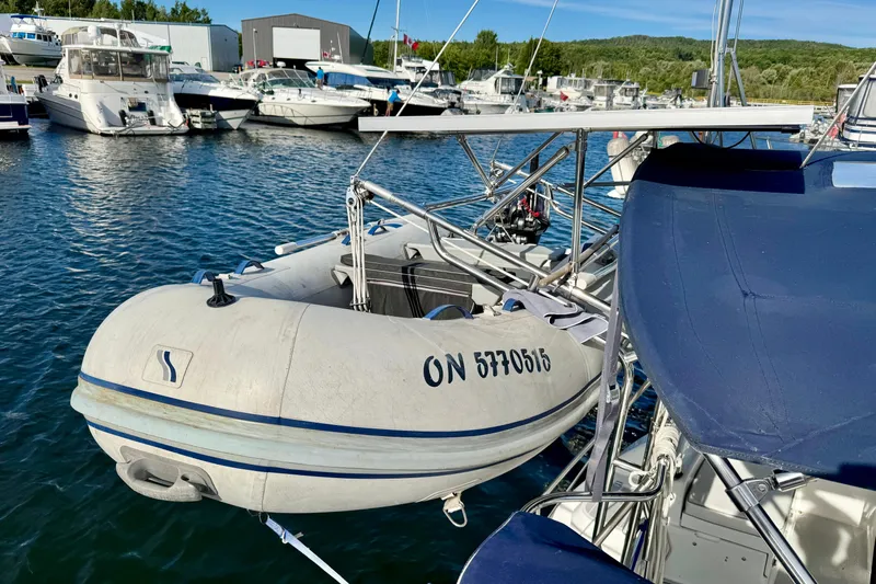 Ostrich Yacht Photos Pics Docked Catalina 42 MkII sailboat with inflatable dinghy, 2004 model, in a marina setting.
