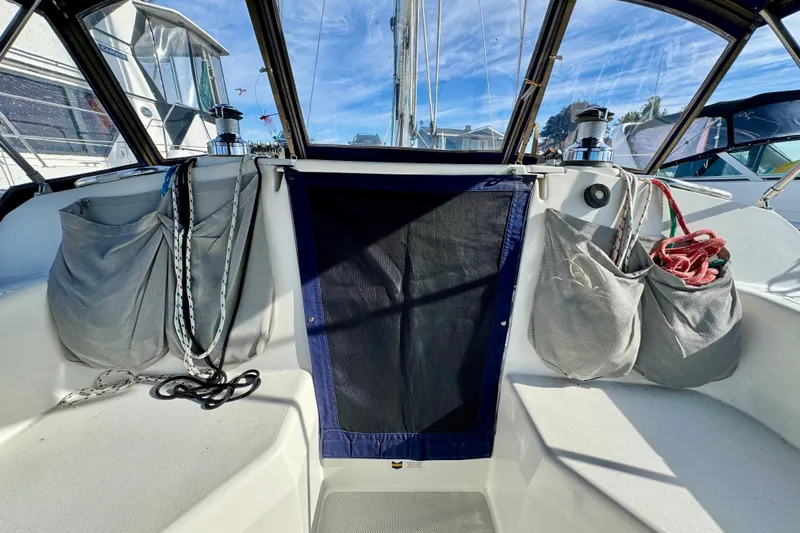 Ostrich Yacht Photos Pics 2004 Catalina 42 MkII cockpit with ropes and storage bags under a clear sky.