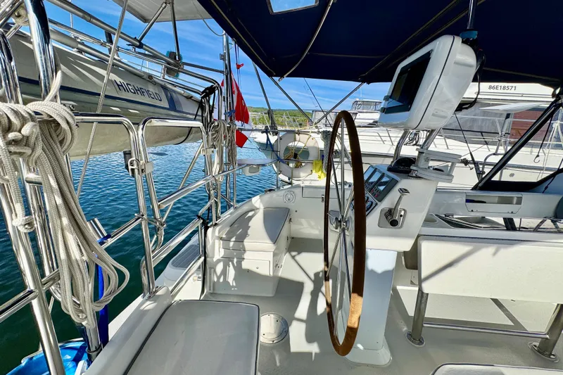 Ostrich Yacht Photos Pics Cockpit of 2004 Catalina 42 MkII sailboat with steering wheel and navigation equipment.