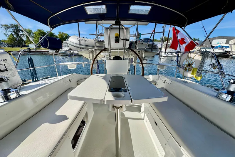 Ostrich Yacht Photos Pics Cockpit of 2004 Catalina 42 MkII sailboat with Canadian flag, docked in marina.