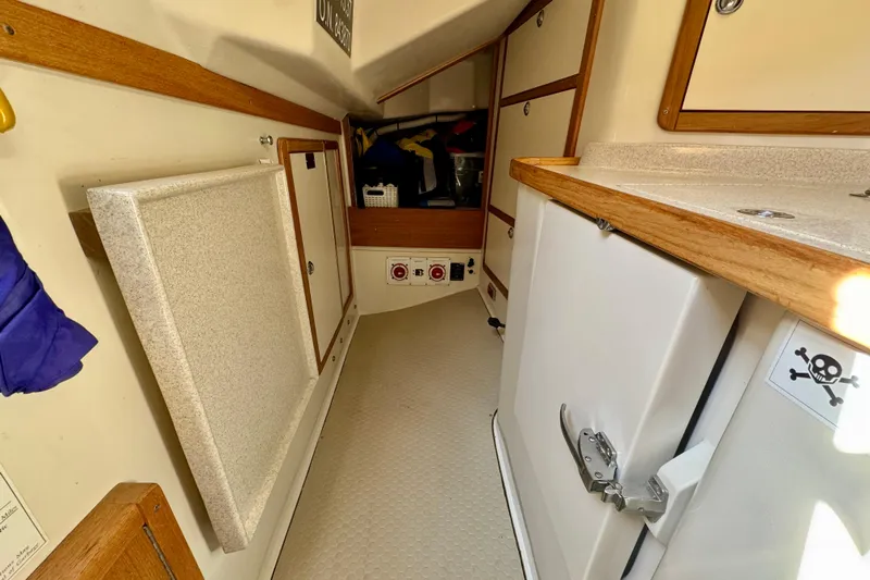Ostrich Yacht Photos Pics Interior of a 2004 Catalina 42 MkII sailboat, featuring storage cabinets and wooden trim.