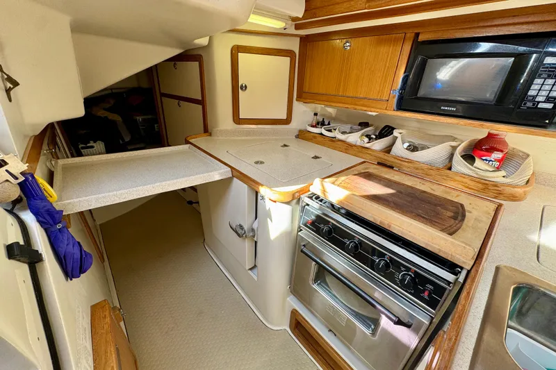 Ostrich Yacht Photos Pics 2004 Catalina 42 MkII yacht kitchen with stove, microwave, and storage cabinets.
