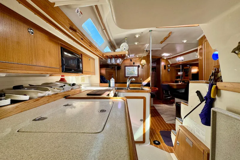 Ostrich Yacht Photos Pics Interior of 2004 Catalina 42 MkII sailboat, featuring a well-equipped kitchen and cozy living area.