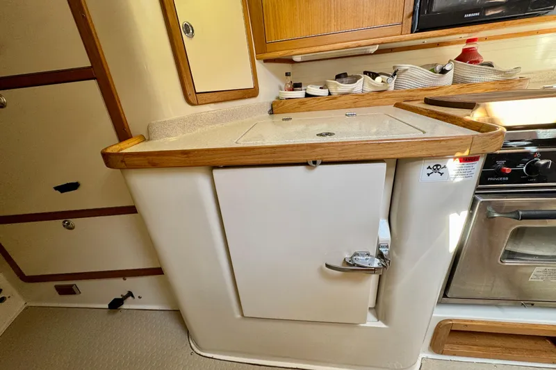 Ostrich Yacht Photos Pics 2004 Catalina 42 MkII yacht kitchen with wooden cabinetry and appliances.