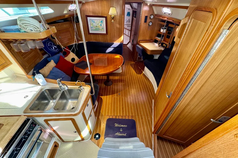 Ostrich Yacht Photos Pics Interior of 2004 Catalina 42 MkII sailboat with wood finish and cozy seating area.