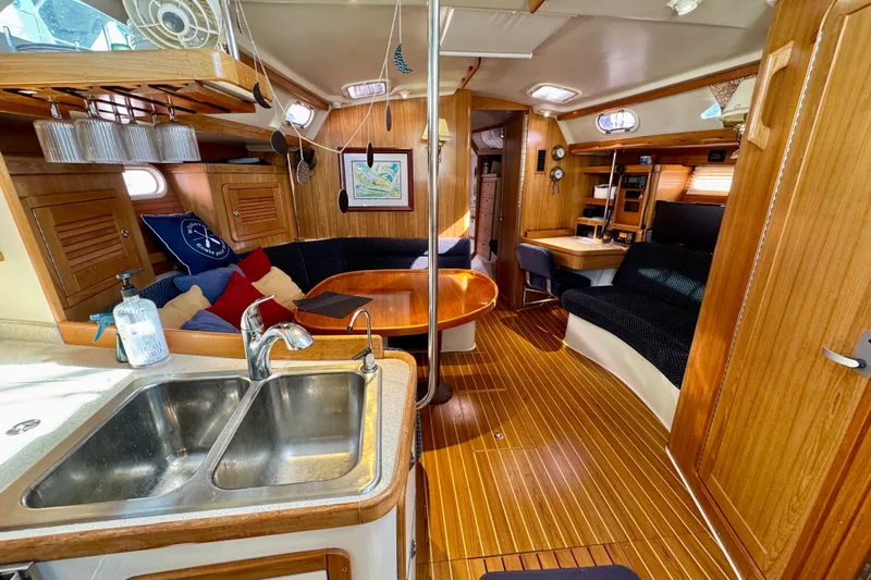 Ostrich Yacht Photos Pics Interior of 2004 Catalina 42 MkII sailboat with wood finish and cozy seating area.