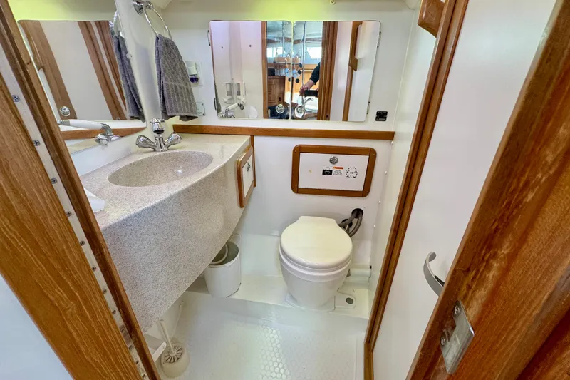 Ostrich Yacht Photos Pics 2004 Catalina 42 MkII yacht bathroom with sink, mirror, and toilet.