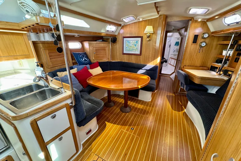 Ostrich Yacht Photos Pics Luxurious 2004 Catalina 42 MkII yacht interior with wood finish and cozy seating area.