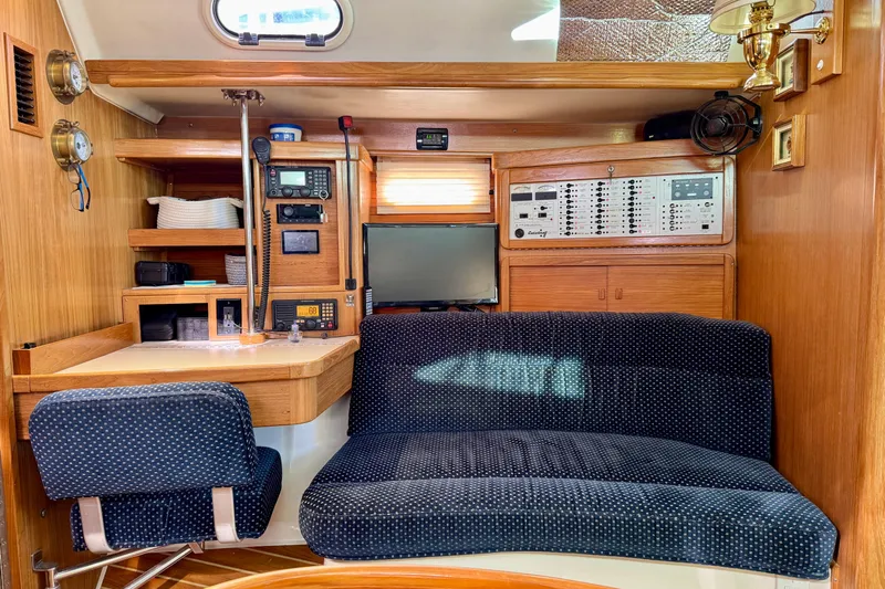 Ostrich Yacht Photos Pics Interior of 2004 Catalina 42 MkII yacht with navigation station and seating area.