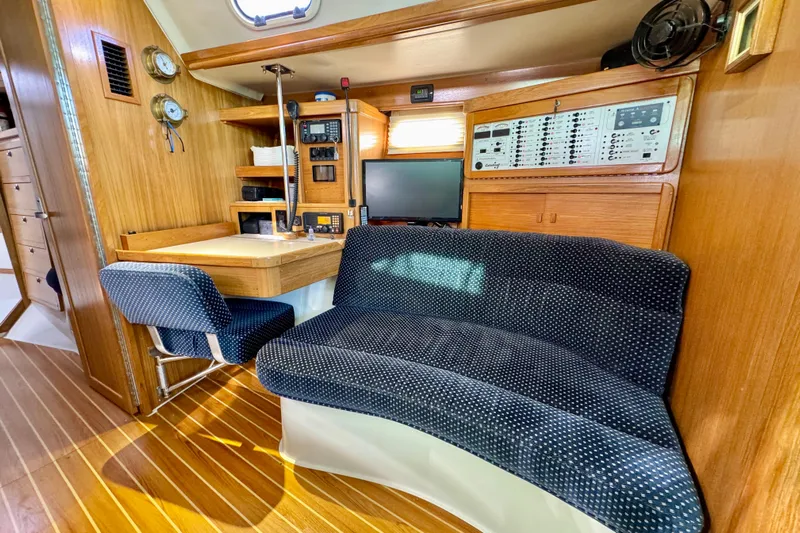 Ostrich Yacht Photos Pics Interior of 2004 Catalina 42 MkII yacht with navigation station and seating area.