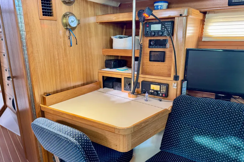 Ostrich Yacht Photos Pics Navigation station in 2004 Catalina 42 MkII sailboat with radio equipment and seating.
