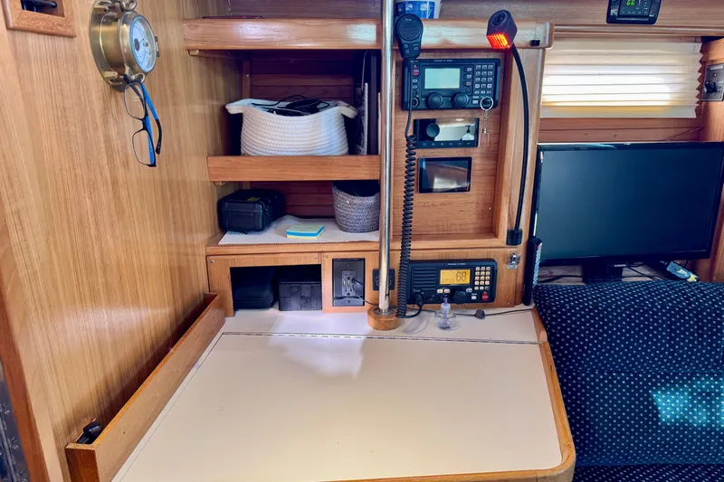 Ostrich Yacht Photos Pics Navigation station inside a 2004 Catalina 42 MkII sailboat with communication equipment and storage.