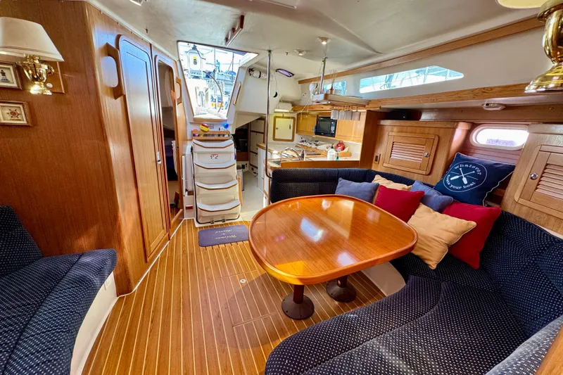 Ostrich Yacht Photos Pics Interior of 2004 Catalina 42 MkII sailboat with cozy seating and wooden table.