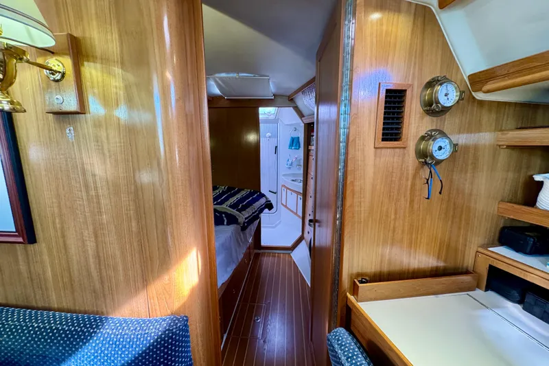 Ostrich Yacht Photos Pics Interior of 2004 Catalina 42 MkII sailboat with wood paneling and cozy cabin layout.