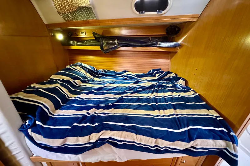 Ostrich Yacht Photos Pics Cozy cabin bed in 2004 Catalina 42 MkII sailboat with striped bedding.