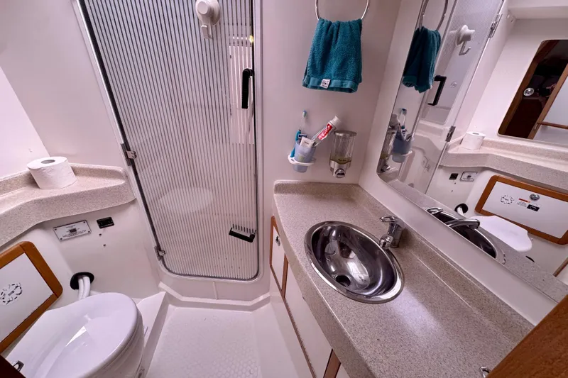 Ostrich Yacht Photos Pics Bathroom interior of 2004 Catalina 42 MkII yacht with sink, shower, and toilet.