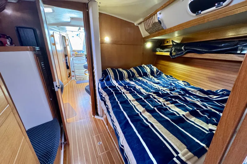 Ostrich Yacht Photos Pics Interior of 2004 Catalina 42 MkII sailboat with cozy cabin and striped bedding.