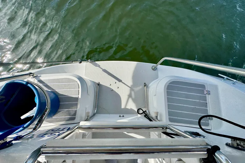 Ostrich Yacht Photos Pics Stern view of 2004 Catalina 42 MkII sailboat with water in the background.