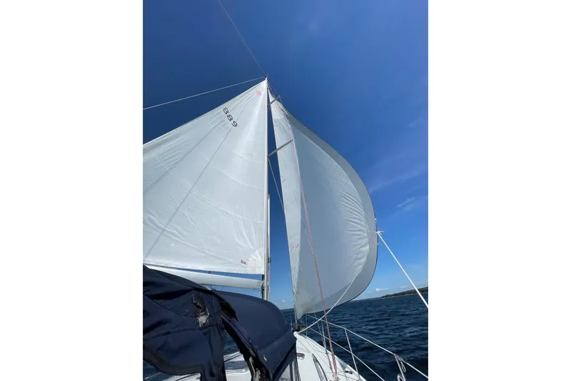 Ostrich Yacht Photos Pics Sailing on a 2004 Catalina 42 MkII with white sails against a clear blue sky.