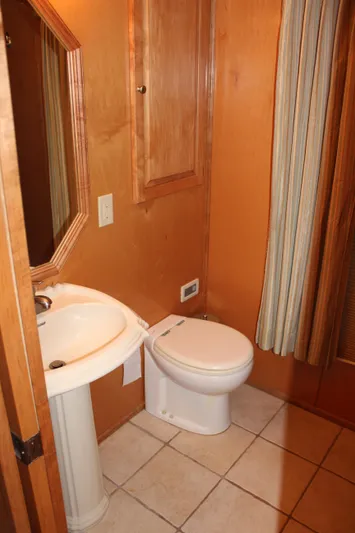  Yacht Photos Pics 2007 Legacy Yachts Majestic bathroom with pedestal sink and toilet, featuring wood accents.