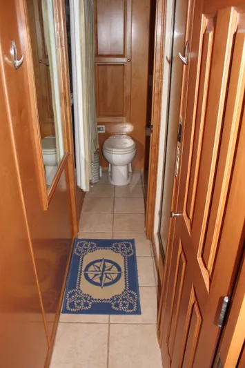  Yacht Photos Pics 2007 Legacy Yachts Majestic bathroom with wooden cabinetry and nautical-themed rug.