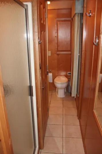  Yacht Photos Pics 2007 Legacy Yachts Majestic bathroom with shower, wooden cabinetry, and tiled floor.