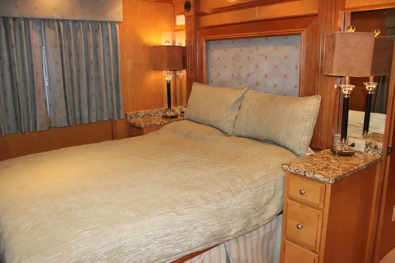  Yacht Photos Pics Luxurious bedroom interior of 2007 Legacy Yachts Majestic with elegant bedding and wood accents.