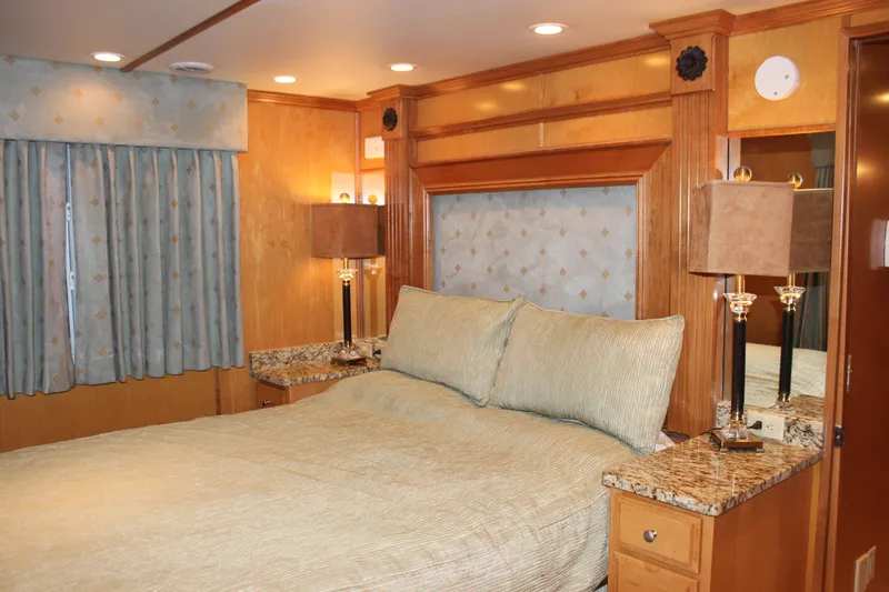  Yacht Photos Pics Luxurious bedroom interior of 2007 Legacy Yachts Majestic with elegant wood finishes and soft lighting.