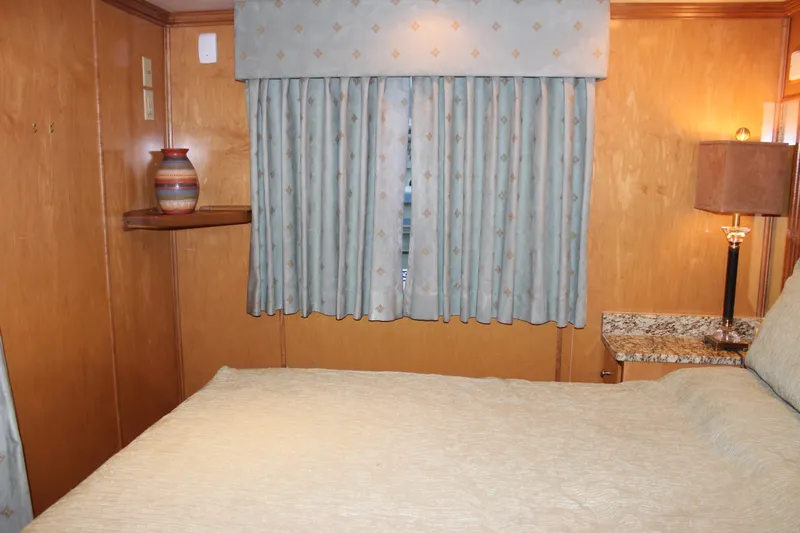  Yacht Photos Pics Cozy bedroom interior of 2007 Legacy Yachts Majestic with wooden walls and elegant decor.