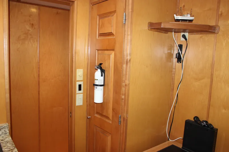  Yacht Photos Pics Interior of 2007 Legacy Yachts Majestic with wooden paneling and fire extinguisher.