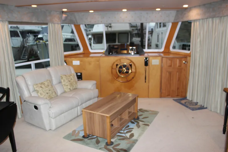  Yacht Photos Pics Interior of 2007 Legacy Yachts Majestic with helm, sofa, and wooden table.