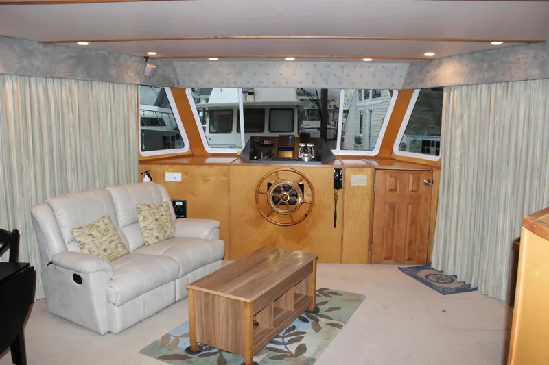  Yacht Photos Pics Interior of 2007 Legacy Yachts Majestic with helm, sofa, and wooden table.