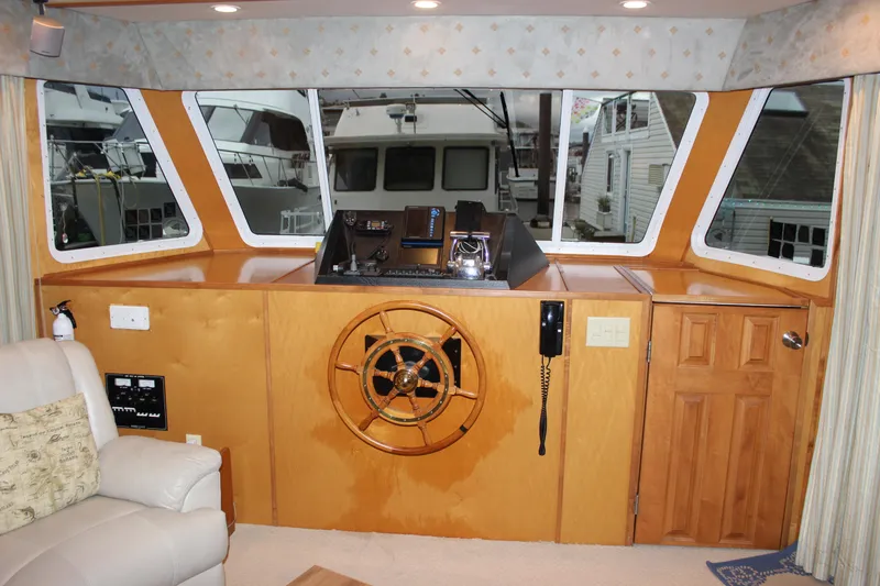  Yacht Photos Pics Interior helm of 2007 Legacy Yachts Majestic with wooden steering wheel and navigation equipment.