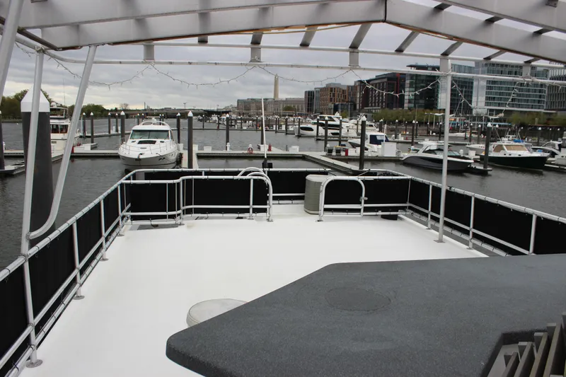  Yacht Photos Pics Upper deck of 2007 Legacy Yachts Majestic overlooking marina with boats and cityscape.