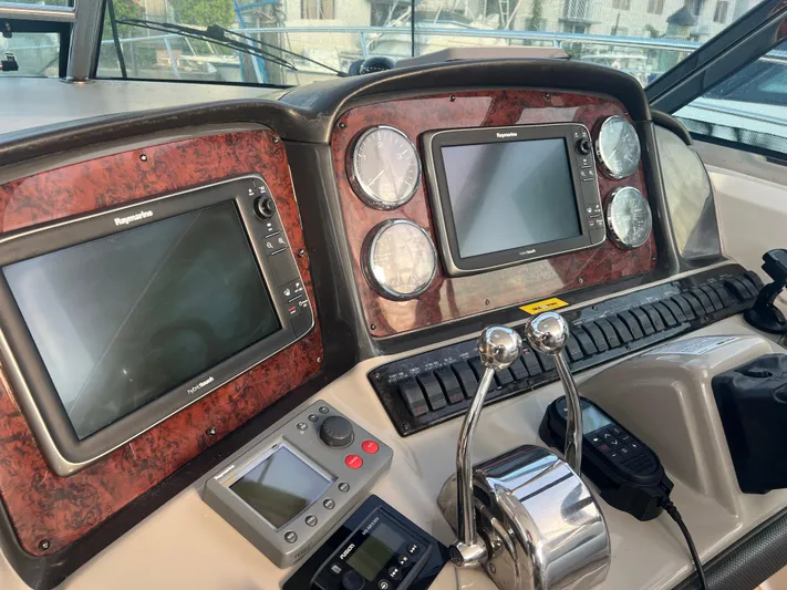 Desert Dream Yacht Photos Pics Control panel of a 2007 Sea Ray 40 Sundancer boat with navigation screens and gauges.