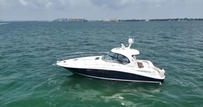 Desert Dream Yacht Photos Pics 2007 Sea Ray 40 Sundancer yacht cruising on open water under a cloudy sky.