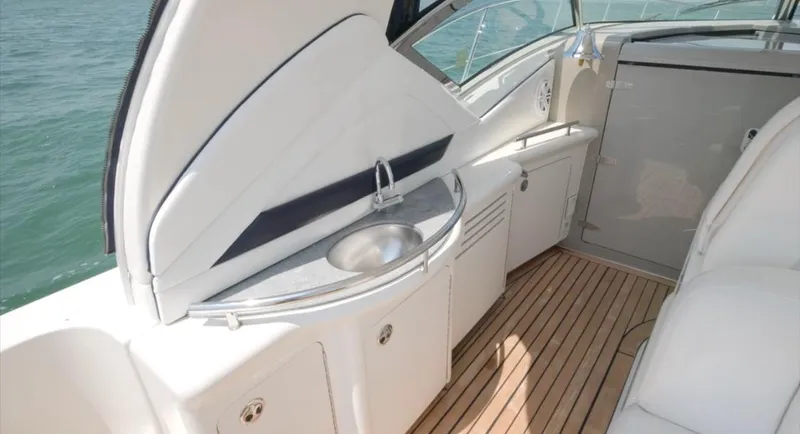 Desert Dream Yacht Photos Pics 2007 Sea Ray 40 Sundancer yacht interior with sleek kitchenette and wooden flooring.