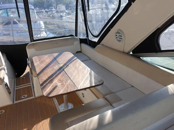 Yacht Photos Pics Interior of 2013 Sea Ray 370 Venture with seating and wooden table.