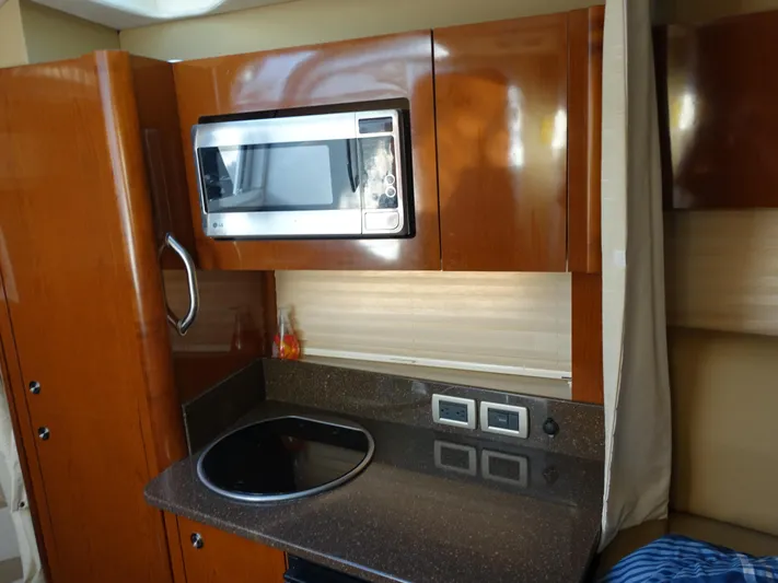  Yacht Photos Pics 2013 Sea Ray 370 Venture kitchen with microwave and stovetop.