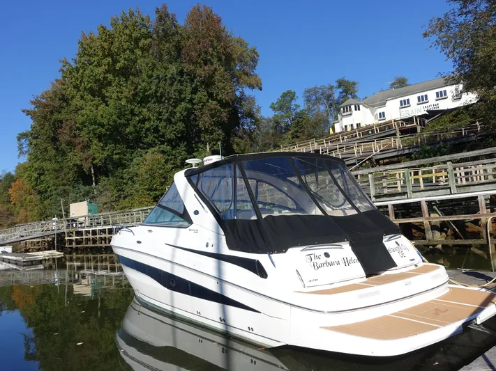  Yacht Photos Pics 2013 Sea Ray 370 Venture boat docked by a scenic waterfront.